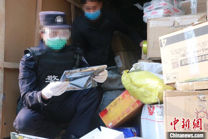 圖為勐康邊檢站民警在對(duì)快遞運(yùn)輸車輛進(jìn)行例行檢查?！钐?攝